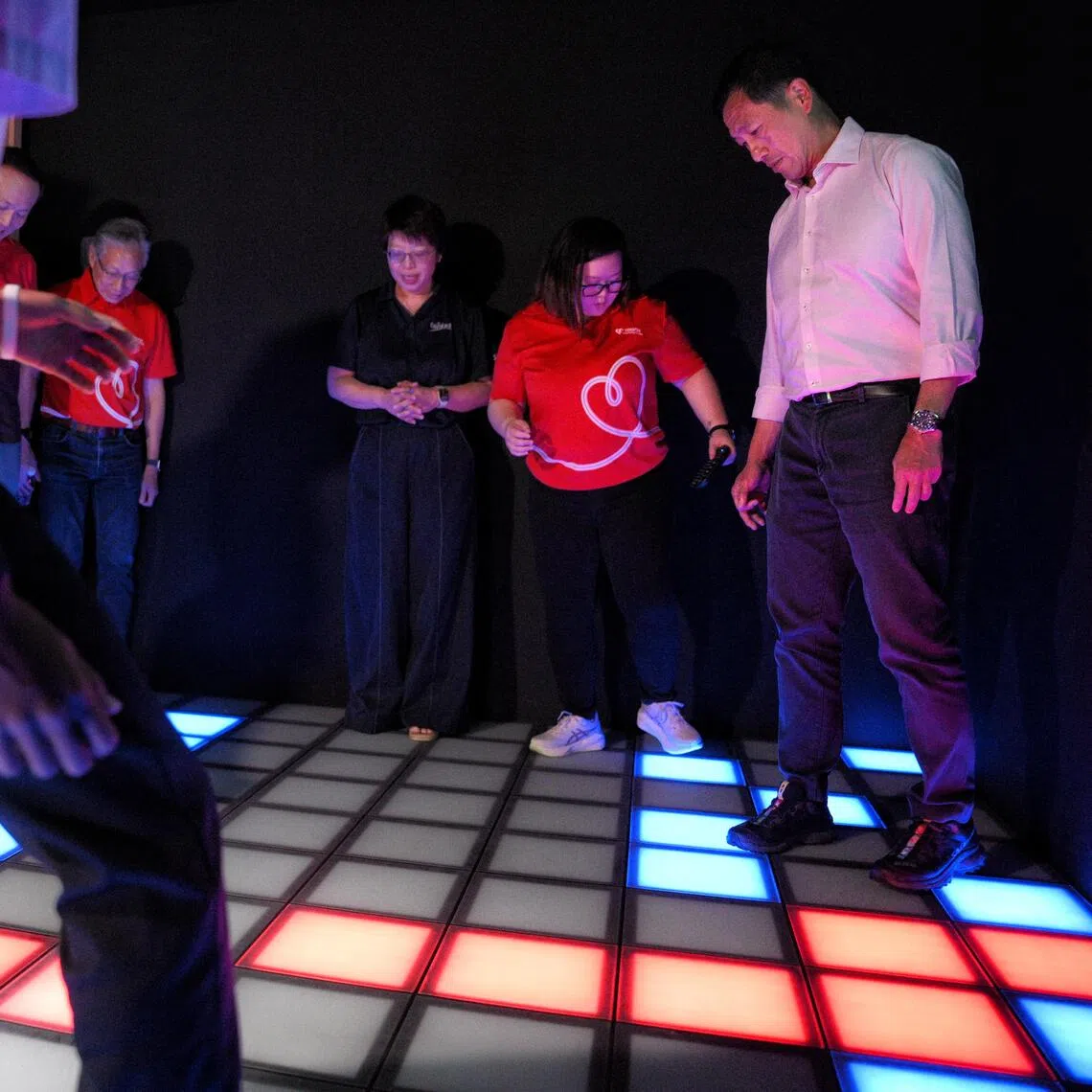 Health Minister Ong Ye Kung (far right) playing “The Floor is Lava” at  MINDCove. The immersive, sensory-based learning space allows young people to step into guided scenarios that mirror real-world digital situations so they can practise emotional regulation.
