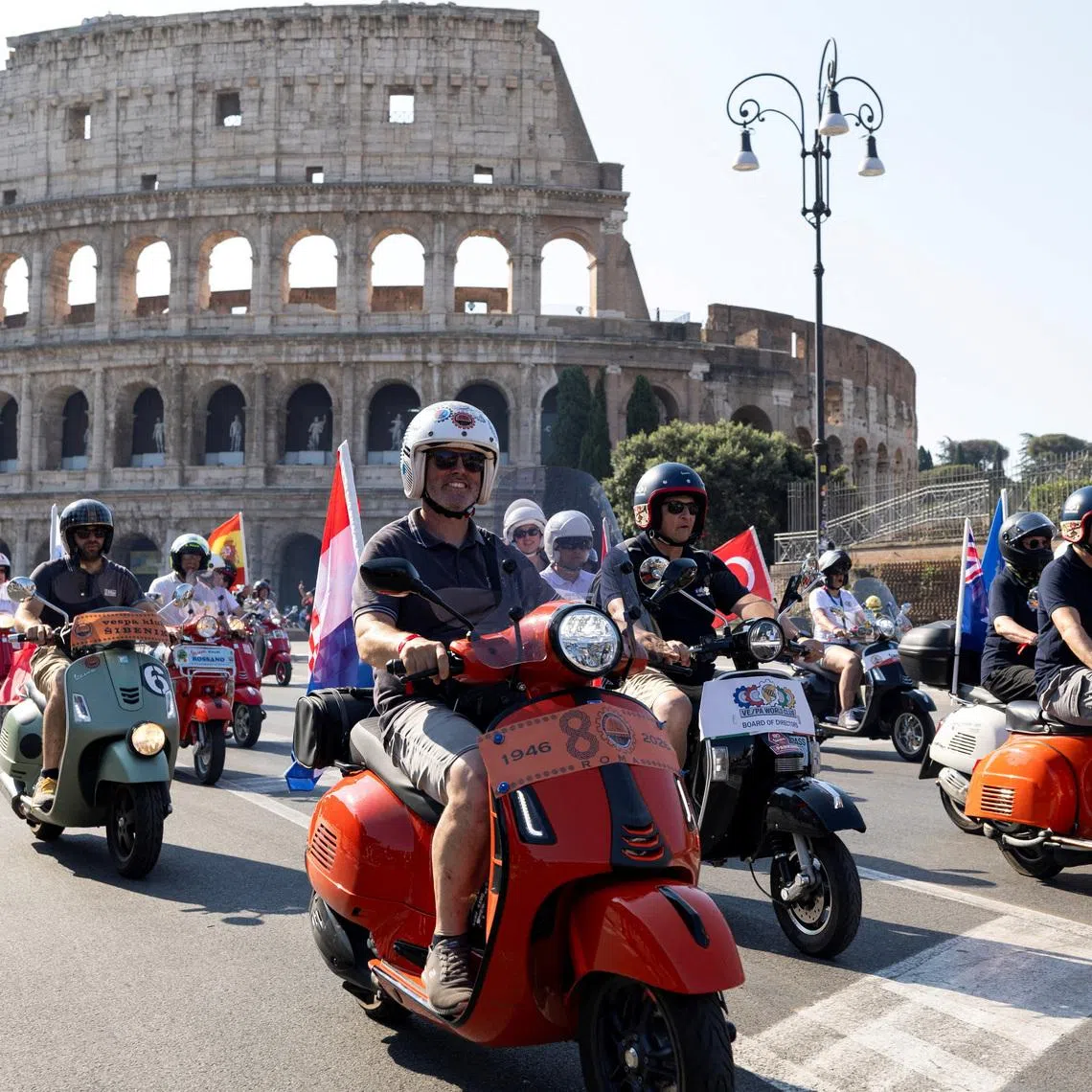 Vespa riders drive past the Colosseum the last day of “Vespa Roma 2026 - 80 Years of an Icon”, a four days global gathering marking the 80th anniversary of the iconic Italian scooter brand, in Rome, Italy, June 27, 2026. REUTERS/Remo Casilli