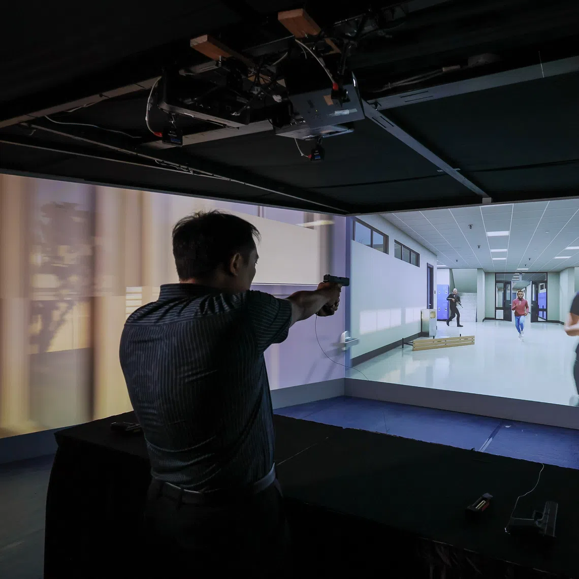A shoot-or-no-shoot scenario is demonstrated at the Home Team Virtual Shooting Range during a pre-event media preview at the Home Team Academy on Sept 7.