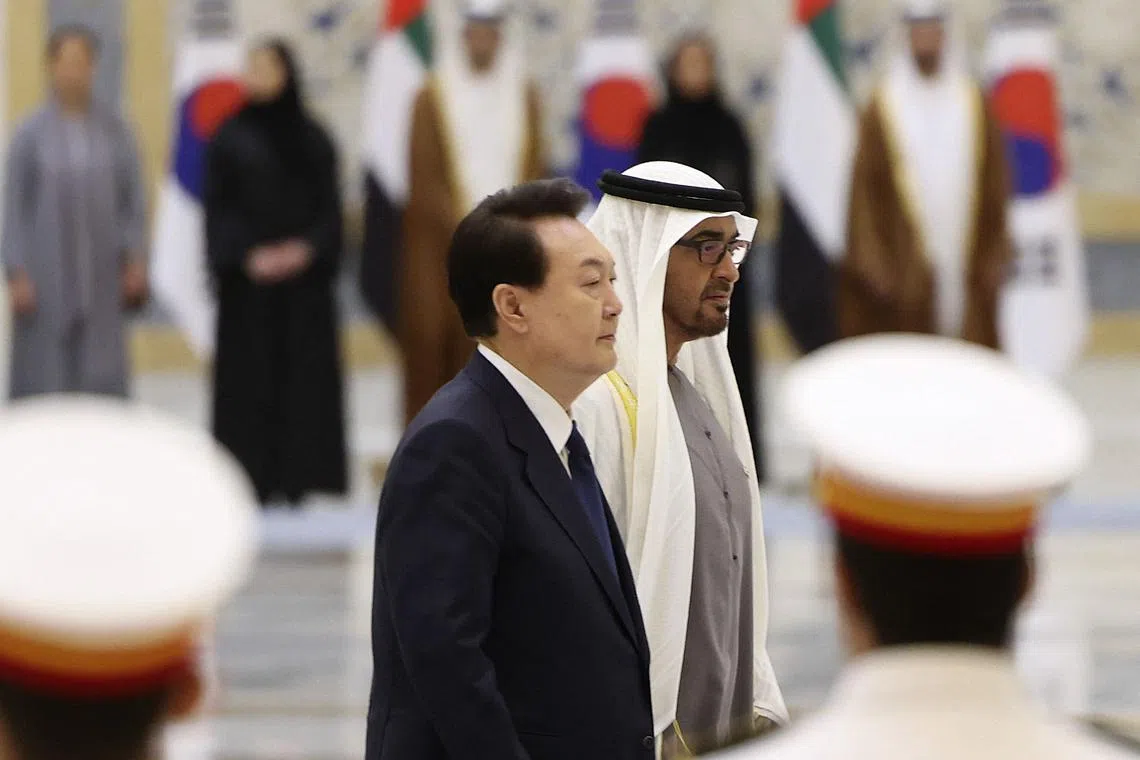 South Korea's President Yoon Suk-yeol (left) walking beside UAE's President Sheikh Mohamed bin Zayed Al-Nahyan during a welcome ceremony at the royal palace in Abu Dhabi, on Jan 15, 2023.