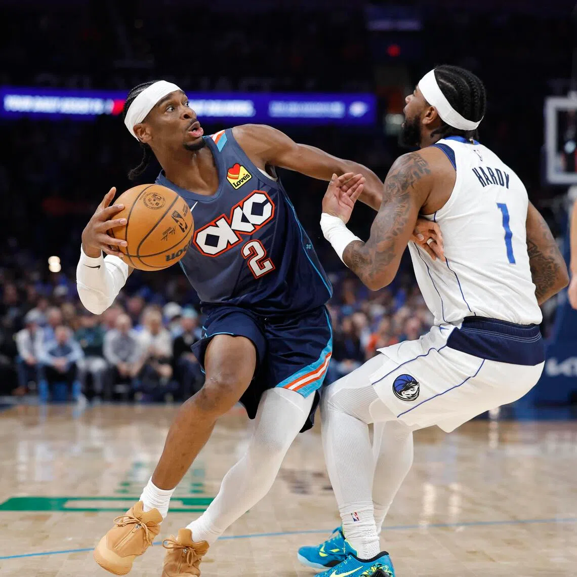 Oklahoma City Thunder guard Shai Gilgeous-Alexander moves the ball around Dallas Mavericks guard Jaden Hardy during the second half at Paycom Center.