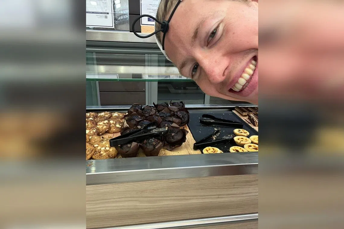 Norwegian swimmer Henrik Christiansen takes a selfie with chocolate muffins at the Olympic Village dining hall, in Paris.