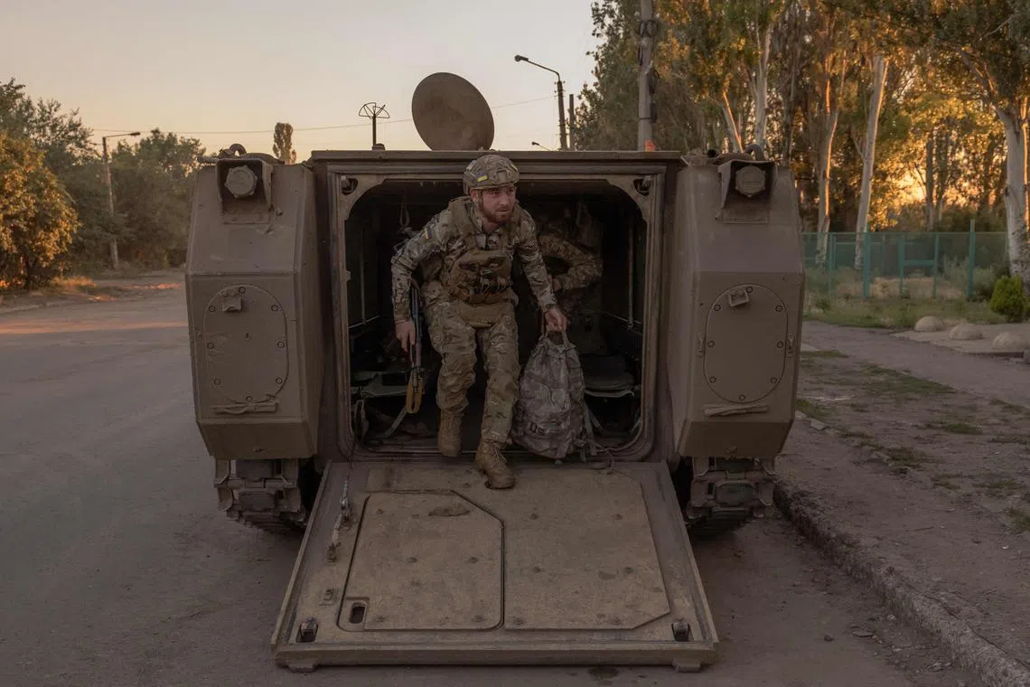 TOPSHOT - A Ukrainian soldier disembarks from a US-made M113 armoured personnel carrier in an undisclosed area in the Donetsk region, on June 19, 2024, amid the Russian invasion of Ukraine. (Photo by Roman PILIPEY / AFP)