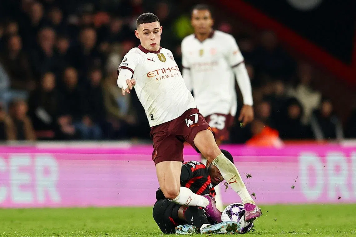 Soccer Football - Premier League - AFC Bournemouth v Manchester City - Vitality Stadium, Bournemouth, Britain - February 24, 2024 Manchester City's Phil Foden in action with AFC Bournemouth's Dango Ouattara REUTERS/Peter Nicholls