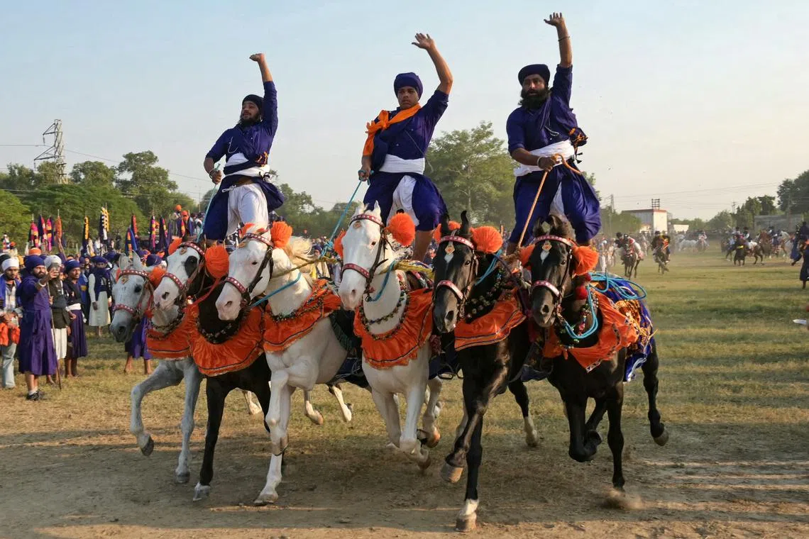 Nihang or Sikh warriors ride horses on the occasion of Fateh Divas in Amritsar, India on November 13.