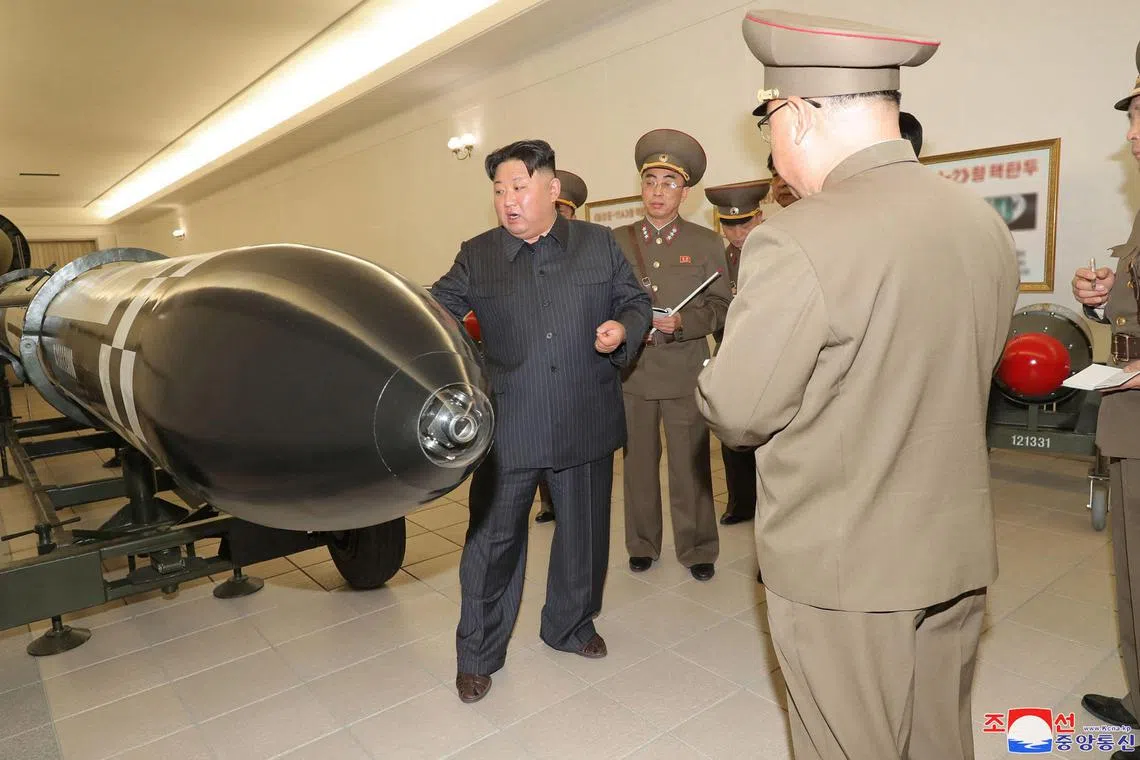 North Korean leader Kim Jong Un (left) inspects a nuclear weaponisation project at an unknown location in North Korea.