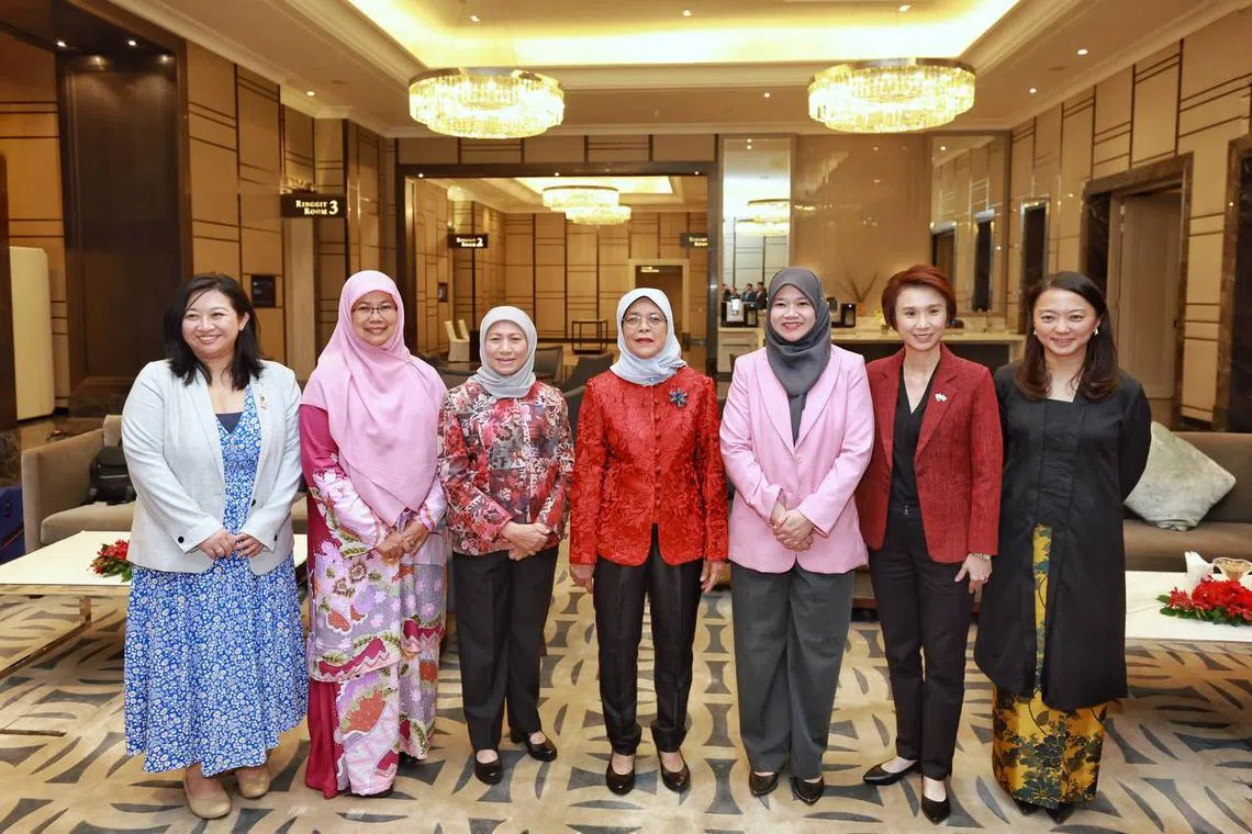 President Halimah Yacob (centre) with (from left) Singapore MP Yeo Wan Ling, PAS women's wing deputy chief Rosni Adam, Malaysia Women, Family and Community Development Minister Nancy Shukri, Malaysia Education Minister Fadhlina Sidek, Singapore Minister of State Low Yen Ling and Malaysia Youth and Sports Minister Hannah Yeoh at the St Regis Hotel Kuala Lumpur on March 21, 2023. 