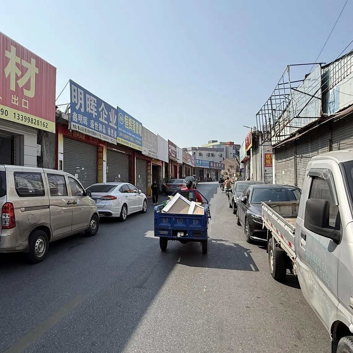 Shuttered storefronts at a wholesale market for building materials in Foshan's Shagang village.