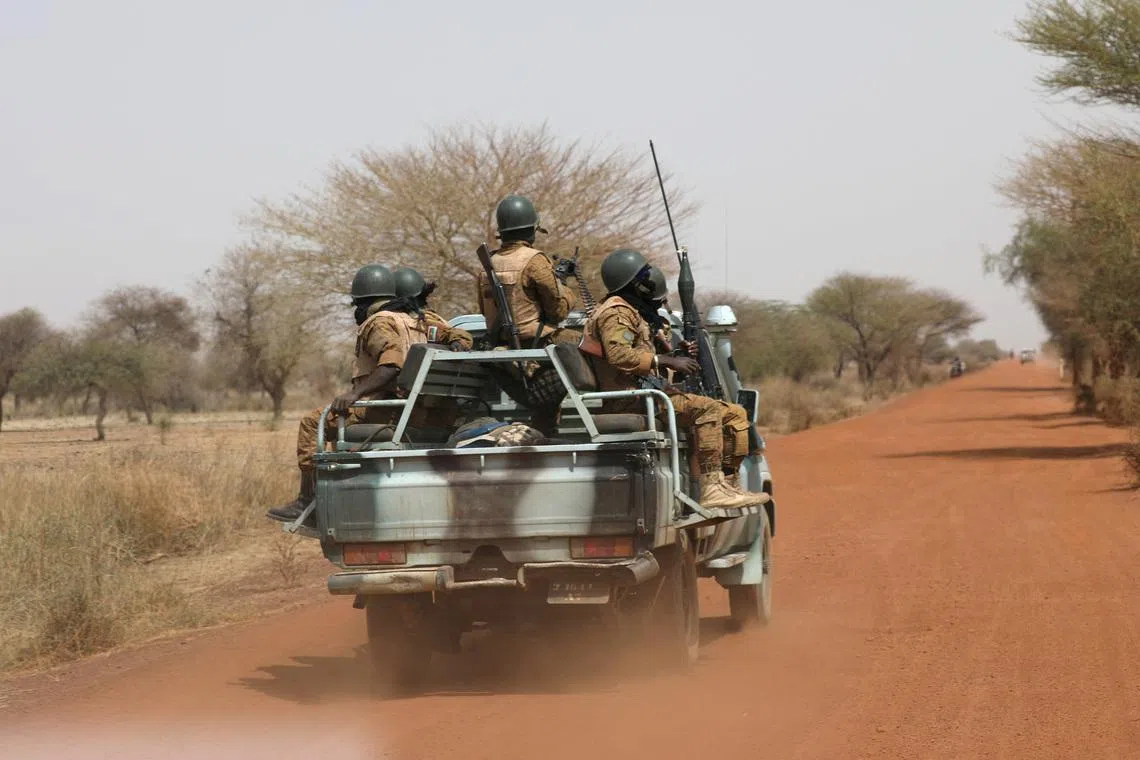 FILE PHOTO: Soldiers from Burkina Faso patrol on the road of Gorgadji in the Sahel region, Burkina Faso, March 3, 2019.   REUTERS/Luc Gnago/File Photo