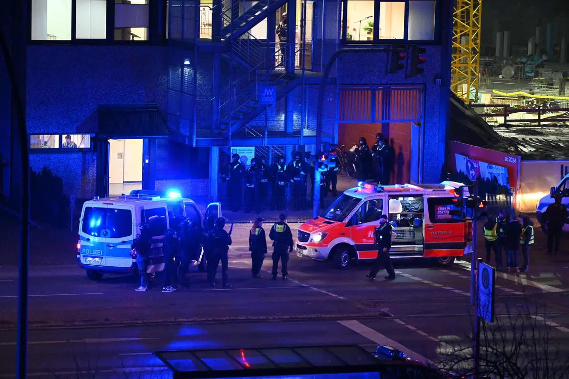 Police and ambulances near a site where several people have been killed in a church shooting in Hamburg, Germany, on March 9.