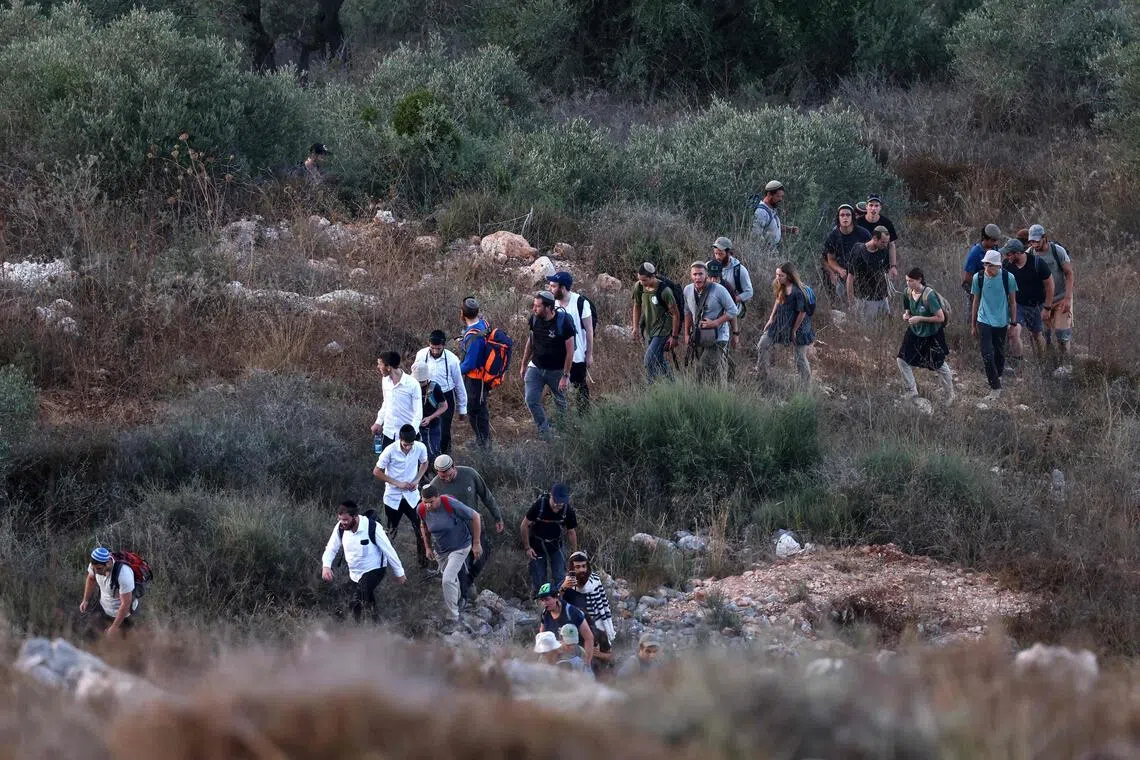 Israeli settlers take part in a march between the villages of Sarra and Tell, south-west of Nablus in the occupied West Bank on July 31.