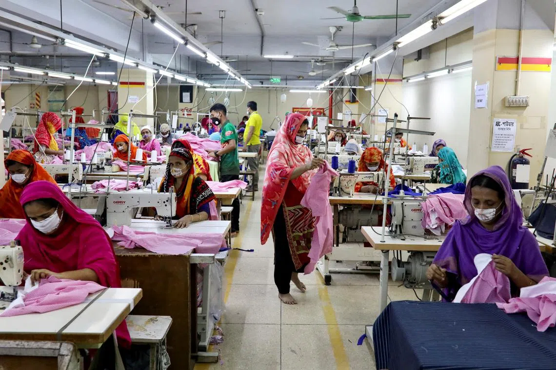 FILE PHOTO: Women work in a garment factory in Dhaka, Bangladesh, May 3, 2020. REUTERS/Mohammad Ponir Hossain/File Photo