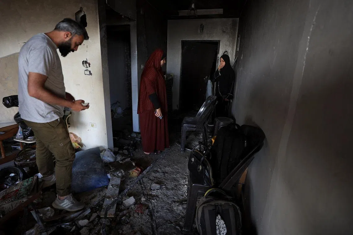 Palestinians inspect the site of an Israeli strike on an apartment in Gaza City, on June 4.