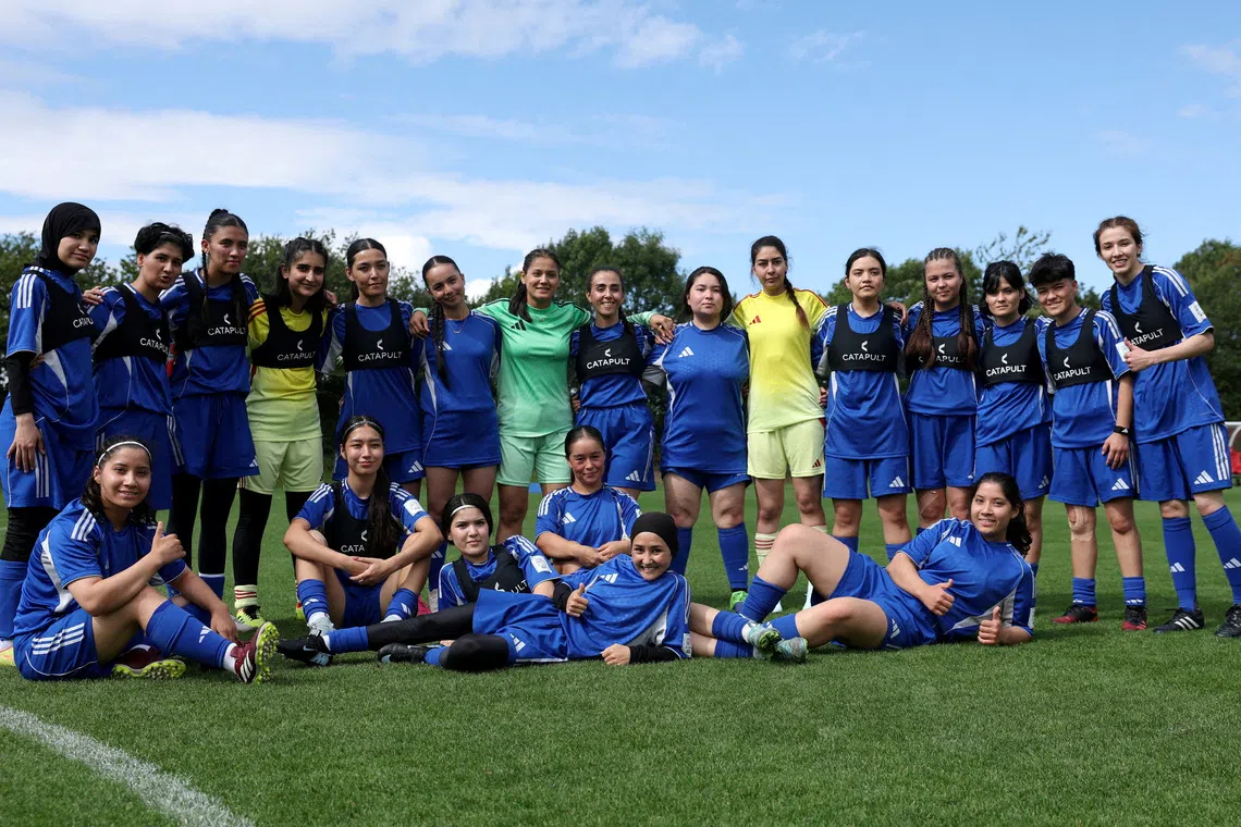 Soccer Football - Members of the Afghan Women's Refugee team pose for a team group during a selection camp at St. George's Park, Burton upon Trent, Britain - August 26, 2025 REUTERS/John Sibley/File Photo