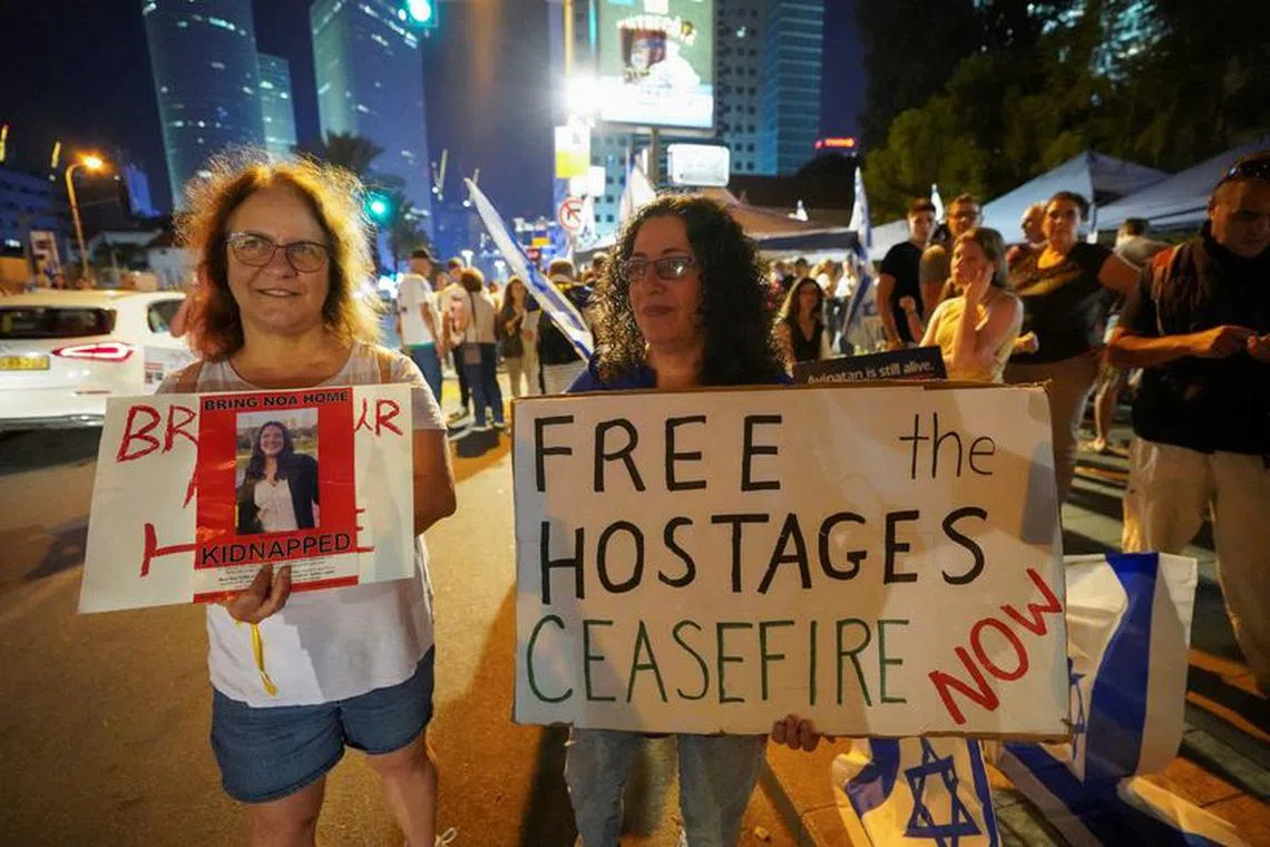 FILE PHOTO: People hold placards during a demonstration to show support and solidarity with the families of hostages who are being held in Gaza, amid the ongoing conflict between Israel and Hamas, in Tel Aviv, Israel, October 21, 2023. REUTERS/Janis Laizans/File Photo