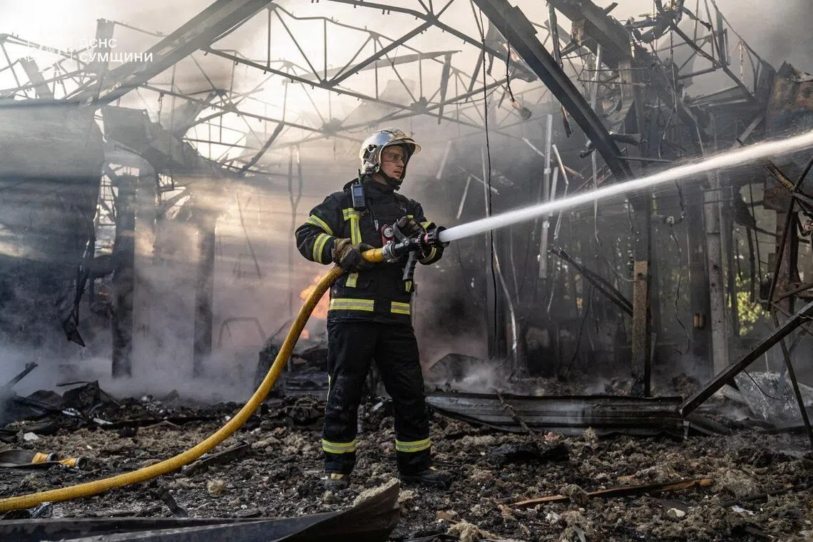 A firefighter working at the site of a Russian drone strike, in Sumy, Ukraine, on Sept 12.