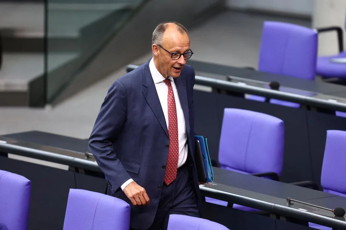German Chancellor Friedrich Merz walks on the day of the Bundestag 2025 to 2029 budget session in Berlin, Germany, July 8, 2025. REUTERS/Liesa Johannssen