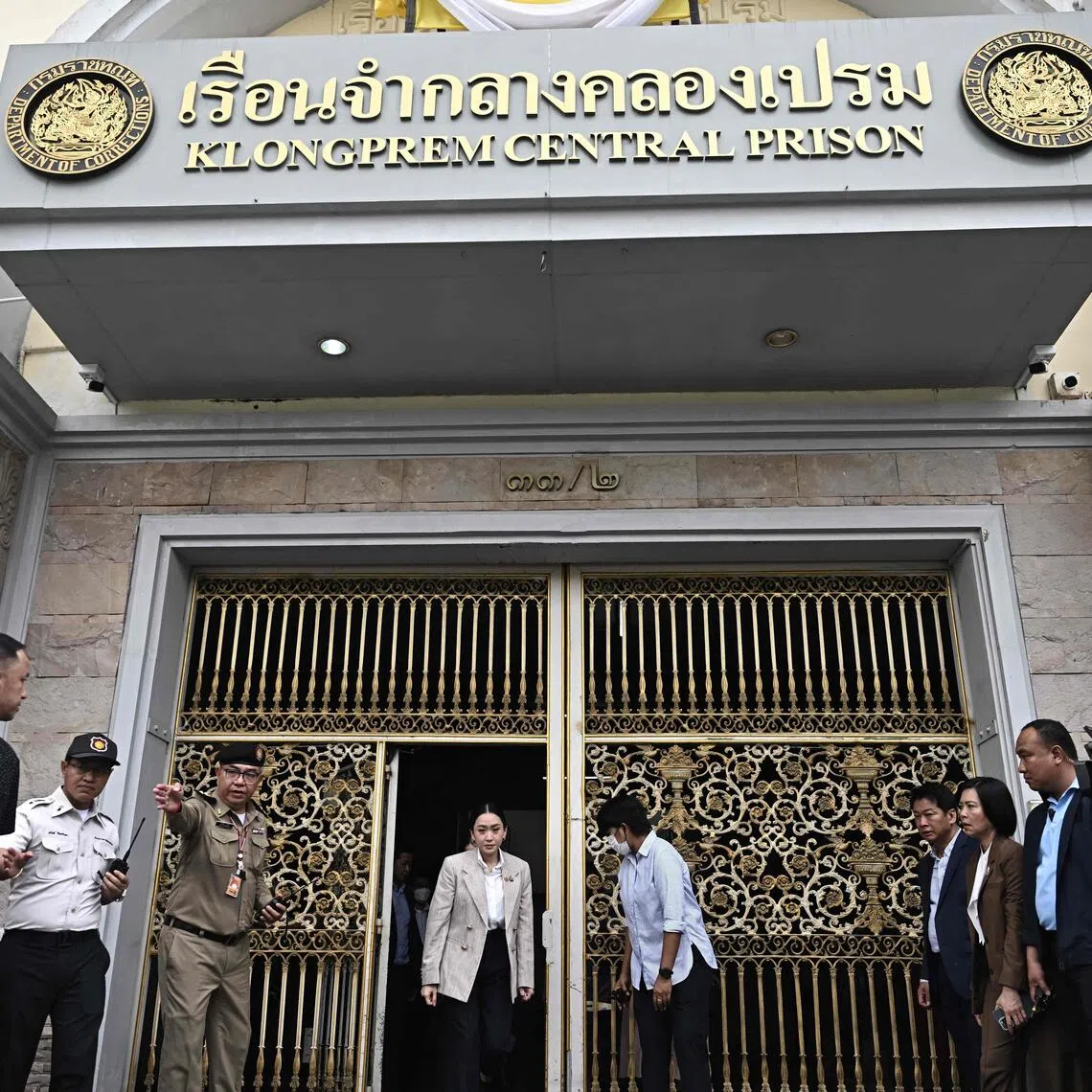 Thailand's sacked prime minister Paetongtarn Shinawatra (C) walks out after visiting her father, former Thai prime minister Thaksin Shinawatra, at Klong Prem Central Prison in Bangkok on September 15, 2025. Thailand's influential ex-prime minister Thaksin Shinawatra is serving a one-year prison sentence after a court ruled that he had improperly served a previous jail term in hospital. (Photo by Lillian SUWANRUMPHA / AFP)