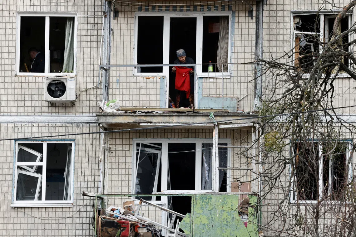 A resident stands in an apartment building damaged by a Russian drone strike, amid Russia’s attack on Ukraine, in Kyiv on Dec 23.