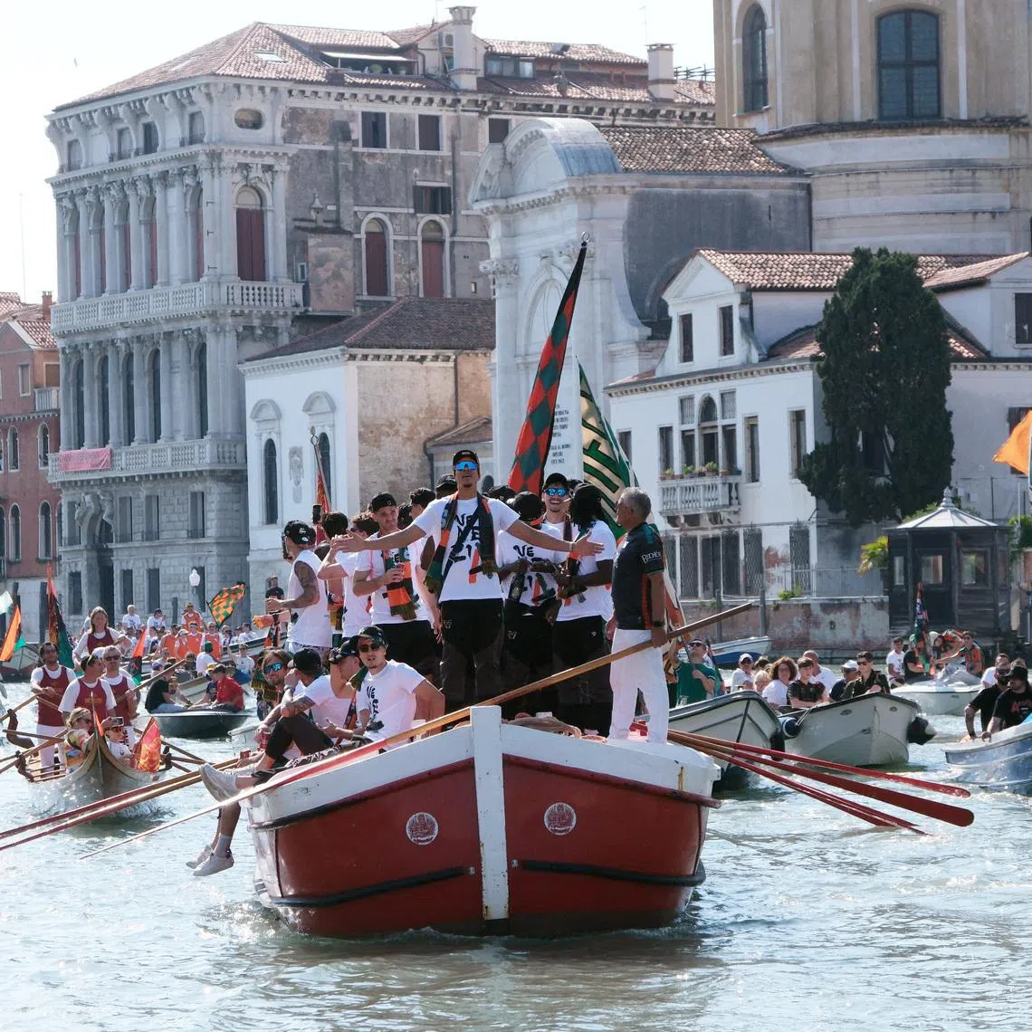 Soccer Football - Serie B - Venezia FC Celebrate Promotion to Serie A - Venice, Italy - May 9, 2026 Venezia FC players celebrate on a gondola after winning promotion to Serie A REUTERS/Manuel Silvestri