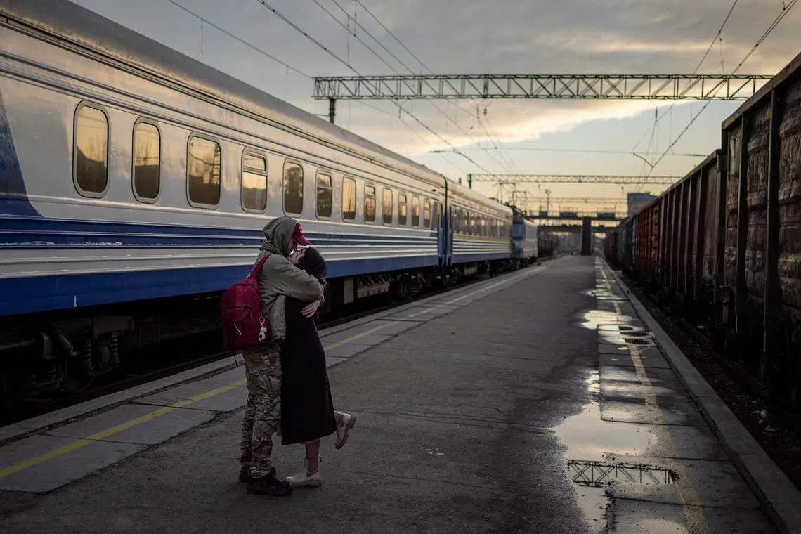 A Ukrainian serviceman Yura greeting his girlfriend Margarita who had not seen him for 6 months and is visiting him during his short break from frontline duty, at the train station in Kramatorsk, amid Russia’s attack on Ukraine, Dec 23, 2023. 