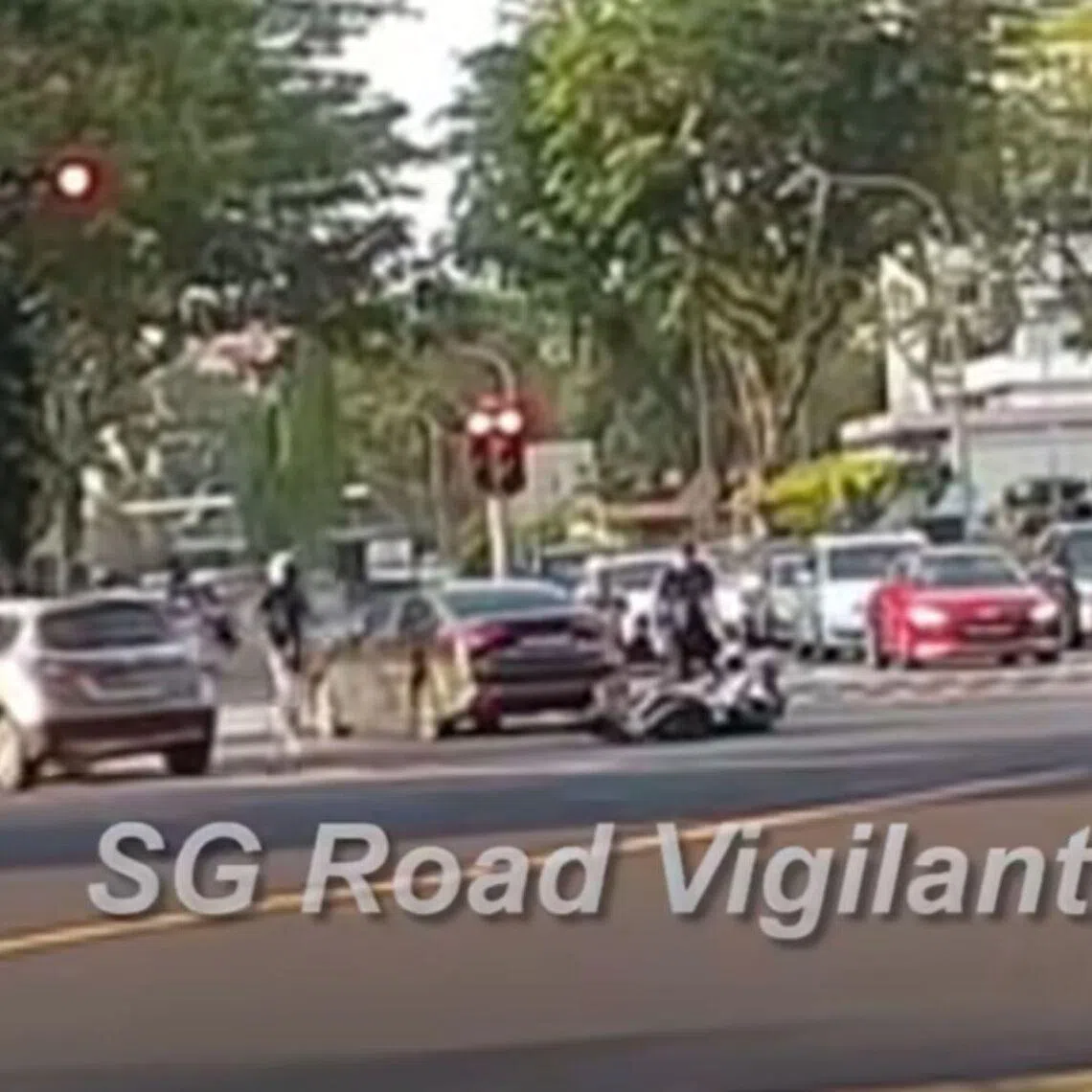 A motorcycle going straight on Commonwealth Avenue West is seen colliding with a car making a right turn onto Clementi Avenue 2. 
