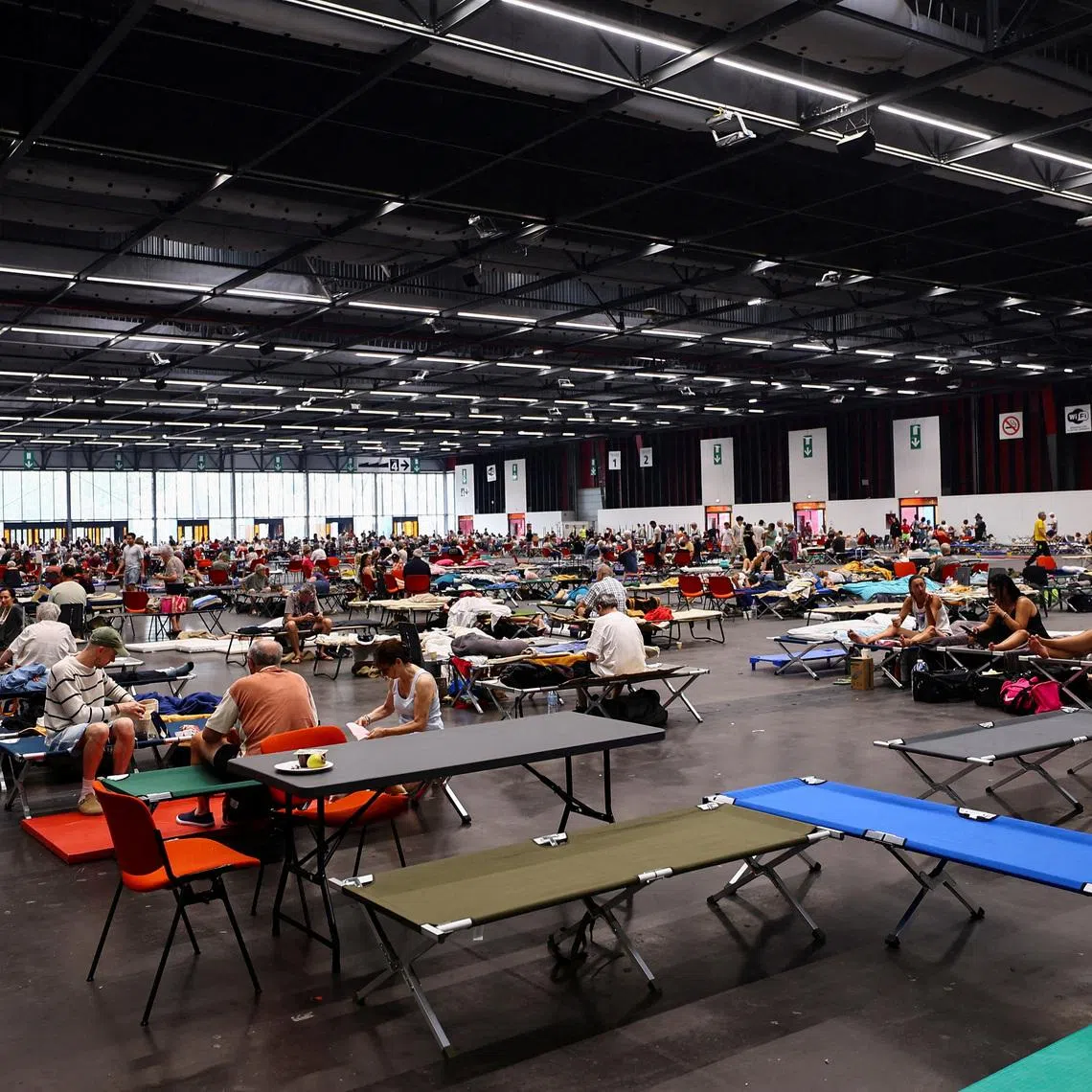 FILE PHOTO: Evacuated residents rest at the Bordeaux-Lac Exhibition Centre, which has been turned into a shelter for people displaced by a wildfire burning nearby amid worsening drought conditions following a heatwave and water shortages across much of France, in Bordeaux, France, July 25, 2026. REUTERS/Manon Cruz/File Photo