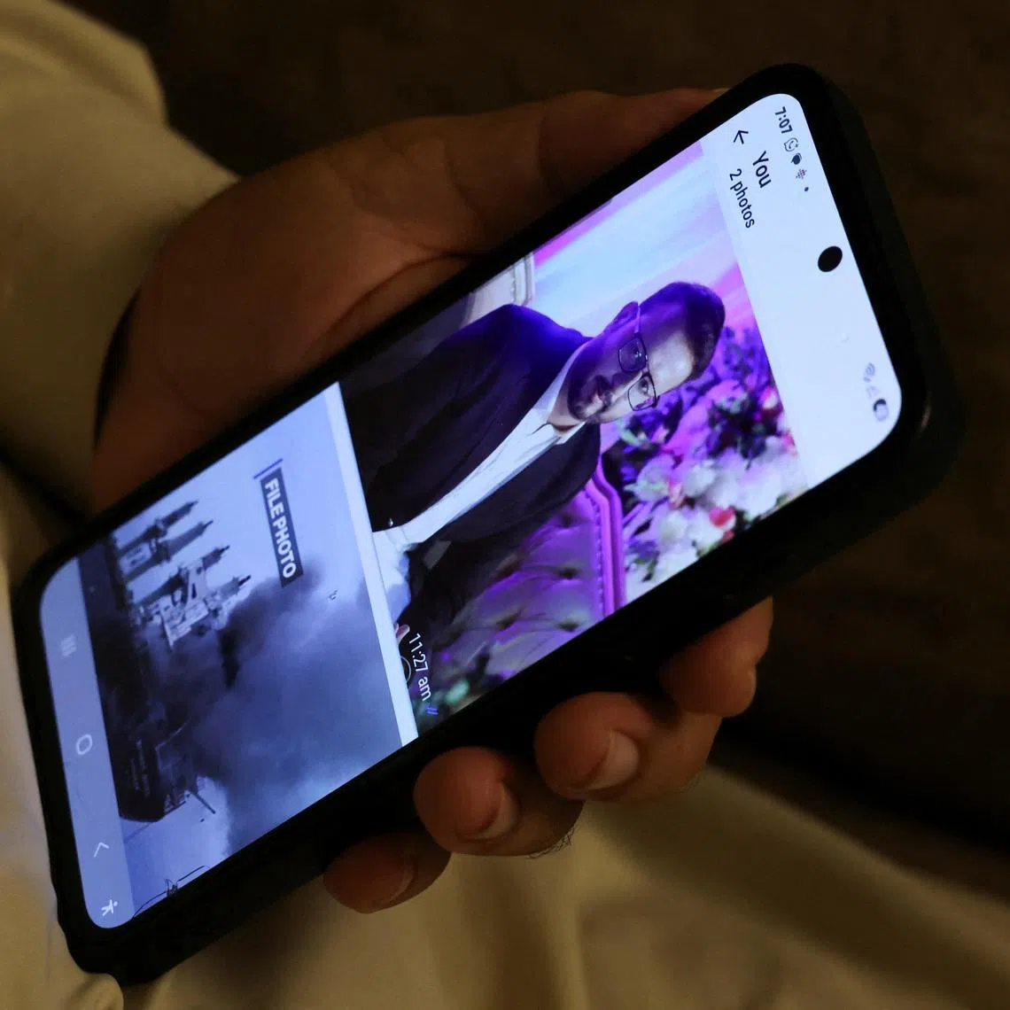 Ghulam Nabi Bahrani holds a mobile phone showing a picture of his son-in-law, Faisal Jatoi, who was the co-pilot (First Officer) of the K2 Airways Boeing 737 cargo plane that crashed in the Arabian Sea, at his home in Karachi, Pakistan, July 8, 2026. REUTERS/Akhtar Soomro