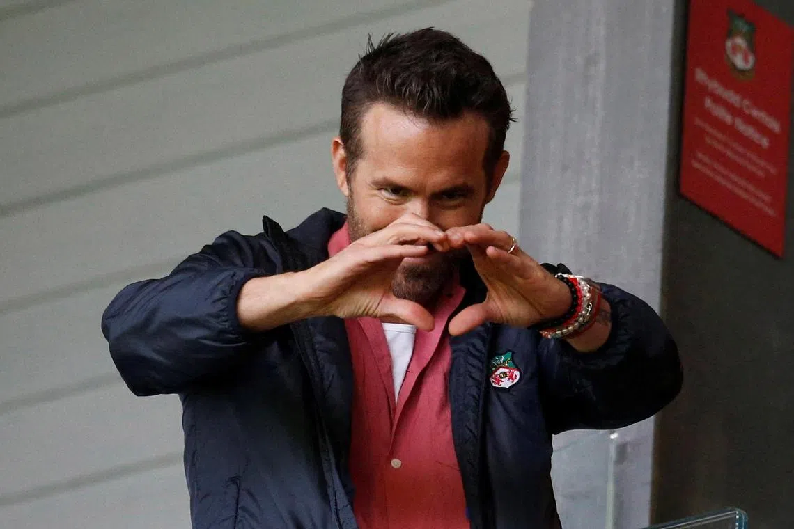 Wrexham co-owner and Hollywood star Ryan Reynolds gesturing to fans ahead of his side's clash with Milton Keynes Dons last August. 