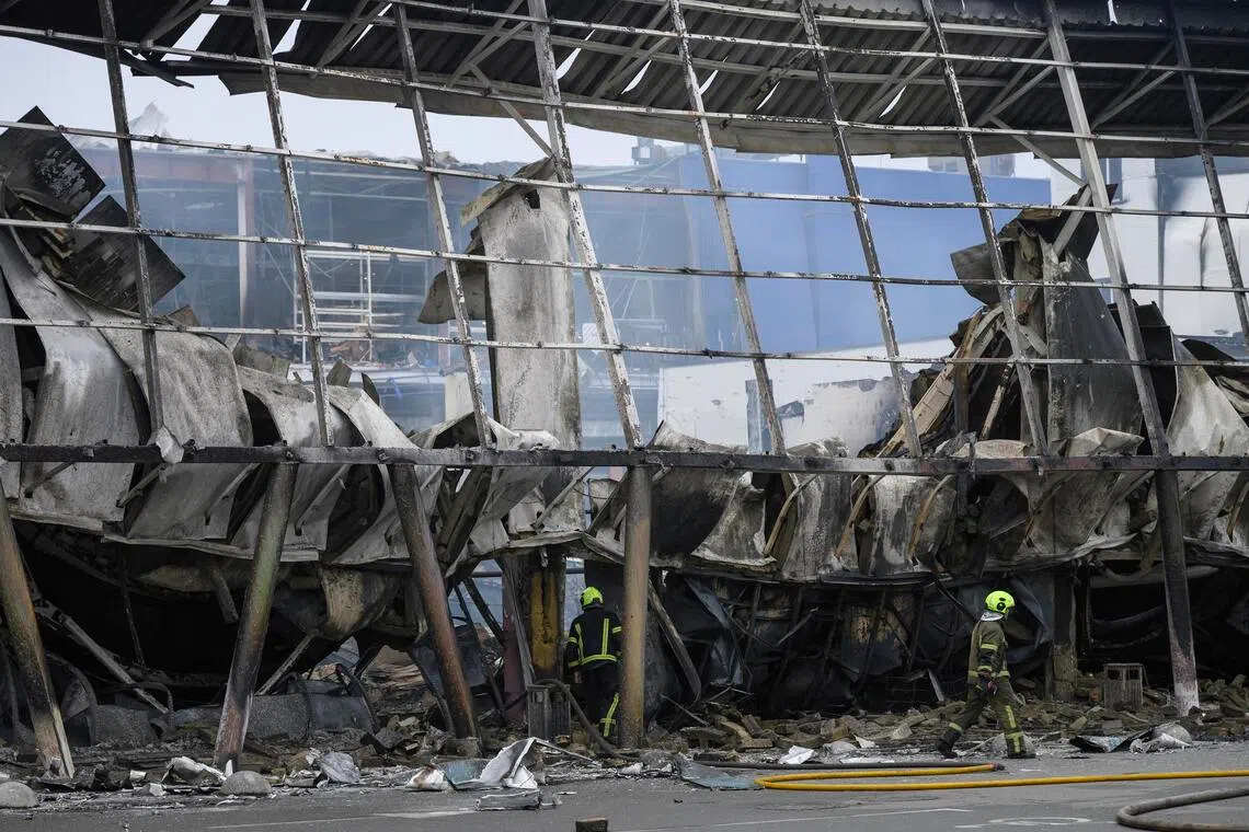 Ukrainian rescuers working at the site of a Russian missile strike on a hypermarket in Kyiv, Ukraine, on Oct 22.