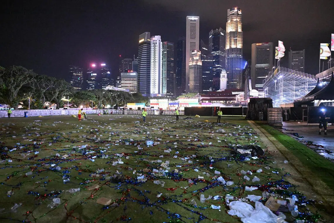 Plastic cups, food packaging and confetti were among the pile of trash left by some of the 65,000 concertgoers after the Robbie Williams concert at The Padang on Sep 18, 2023. Cleaners began to clear the trash about 10 minutes after the concert ended past midnight. It took slightly more than an hour for the trash to be collected into smaller piles and bagged. Rubbish bins could be found around the venue but were mostly full.