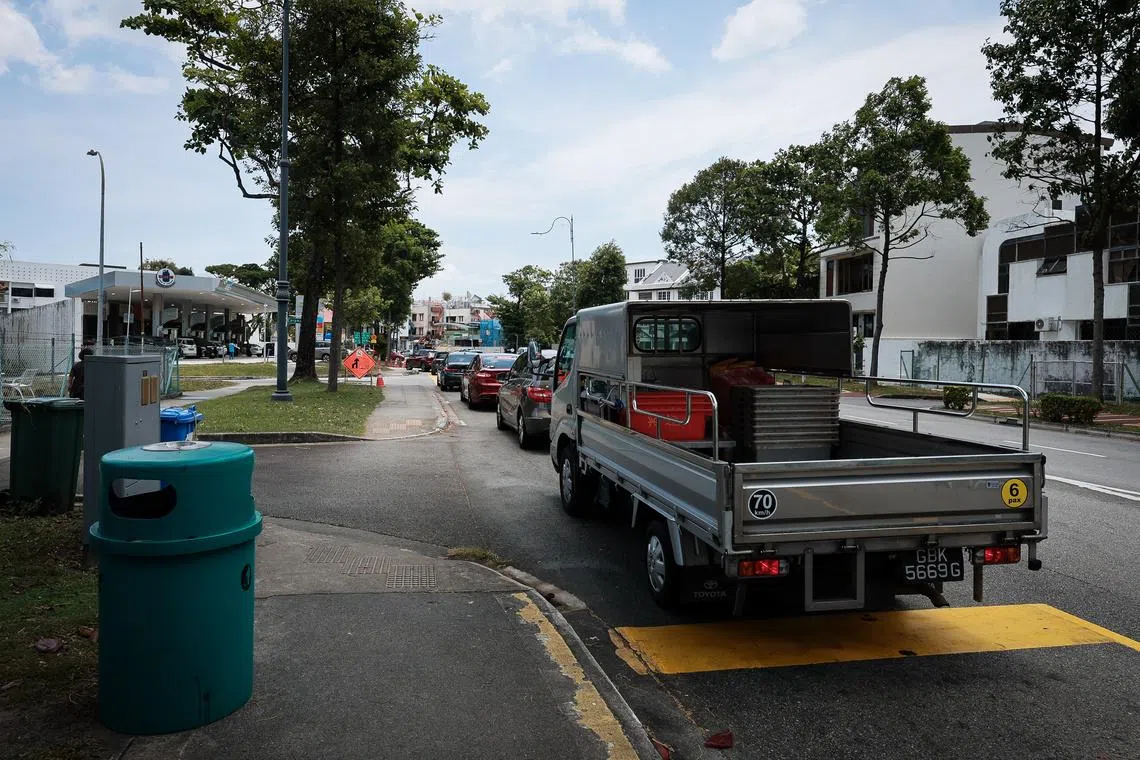 Vehicles queue for petrol at Cnergy station at Dunman Roaf at 12.48pm on March 23.