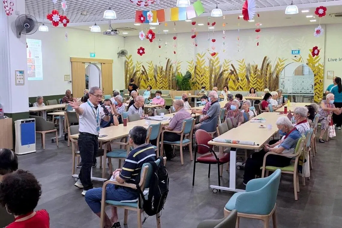 Volunteer Mok Loi Wong telling stories at NTUC Health Day Centre for Seniors (Serangoon Central) on Sept 22.