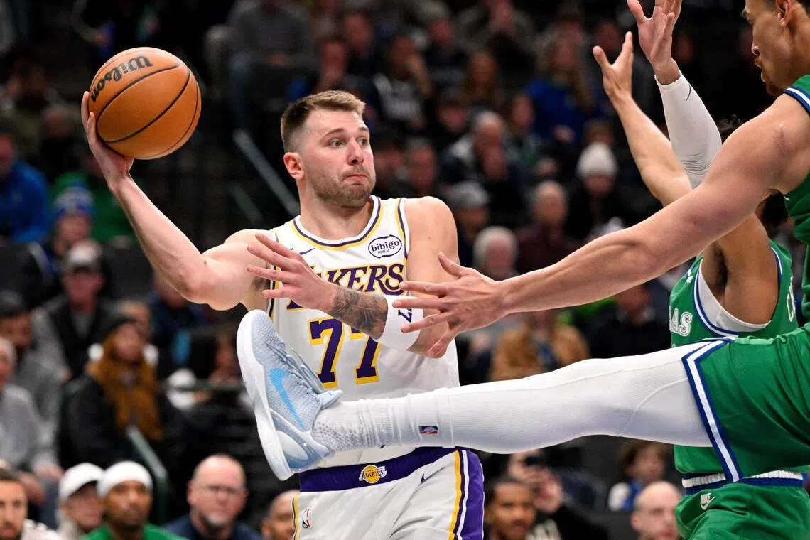 Los Angeles Lakers guard Luka Doncic looking to pass the ball past Dallas Mavericks forward Dwight Powell during the second half of the Lakers' NBA 116-110 win at the American Airlines Center on Jan 24, 2026.