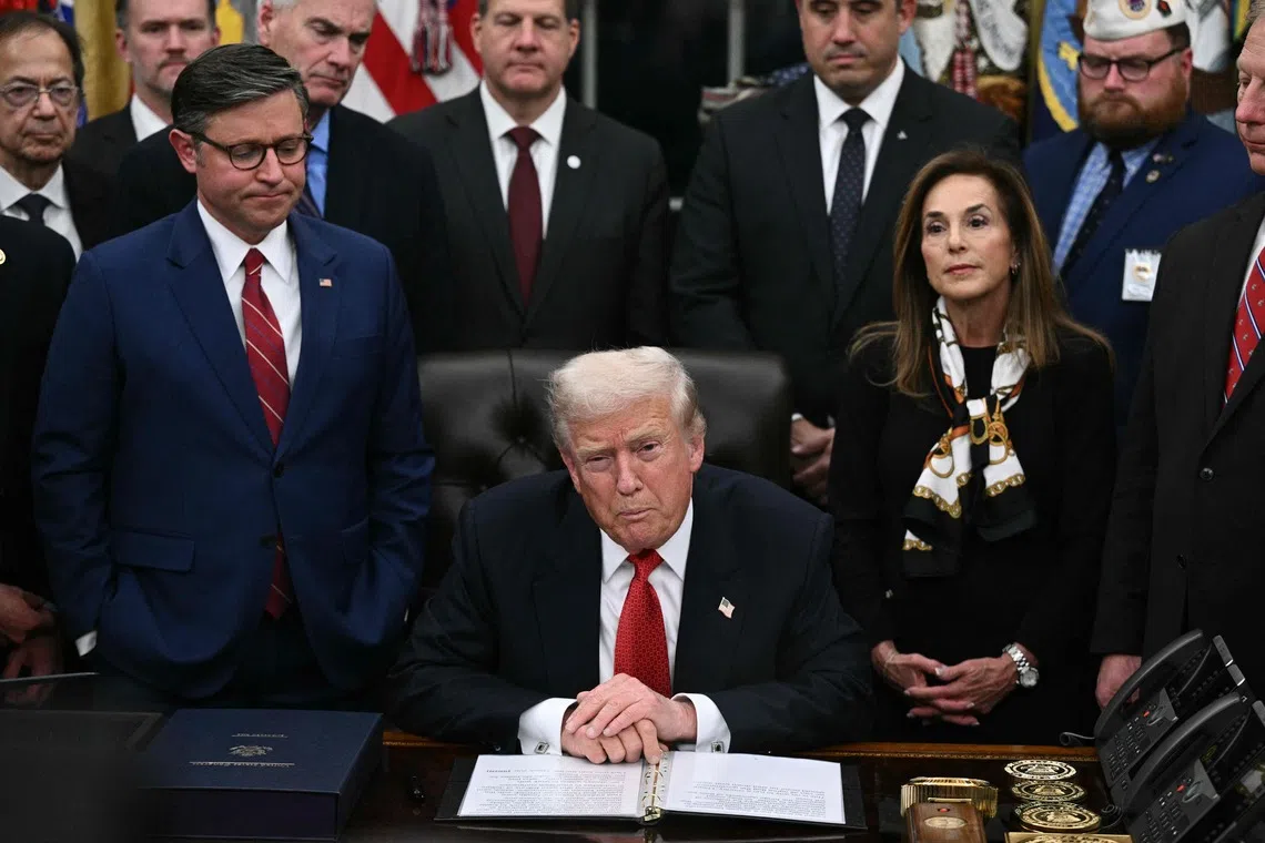 US President Donald Trump while signing the bill package to re-open the federal government at the White House in Washington, DC, on Nov 12.
