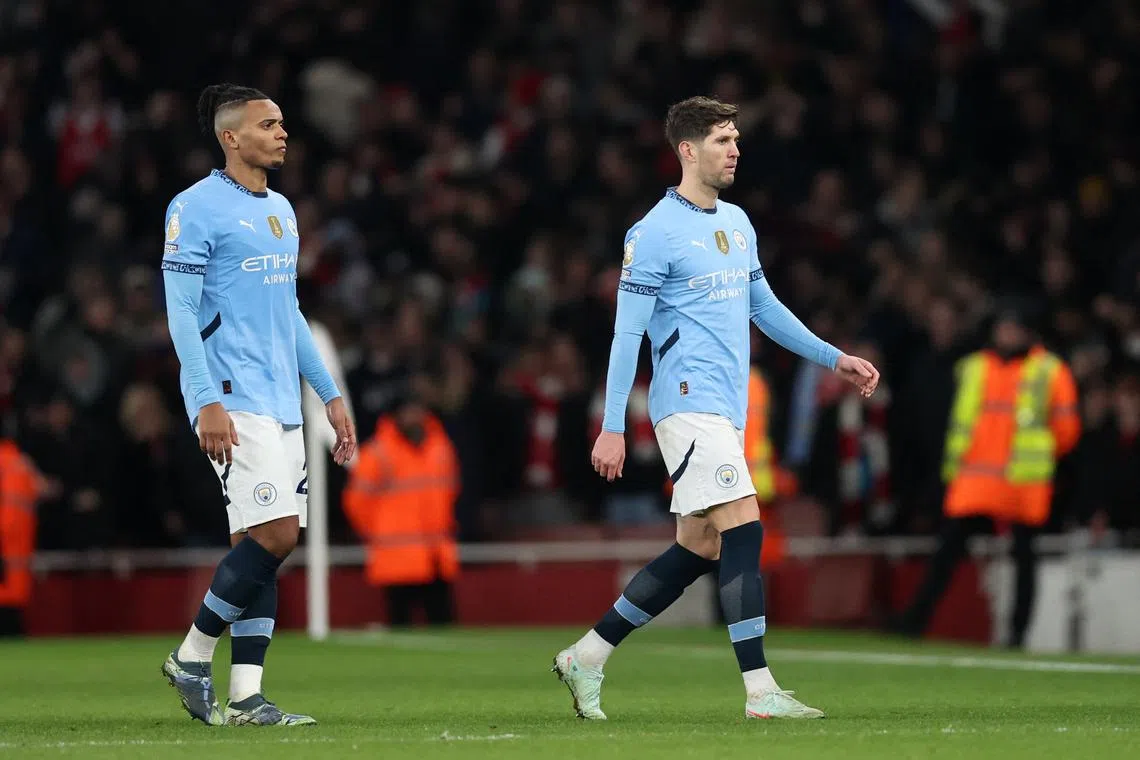 Soccer Football - Premier League - Arsenal v Manchester City - Emirates Stadium, London, Britain - February 2, 2025 Manchester City's Manuel Akanji and John Stones look dejected after the match REUTERS/David Klein