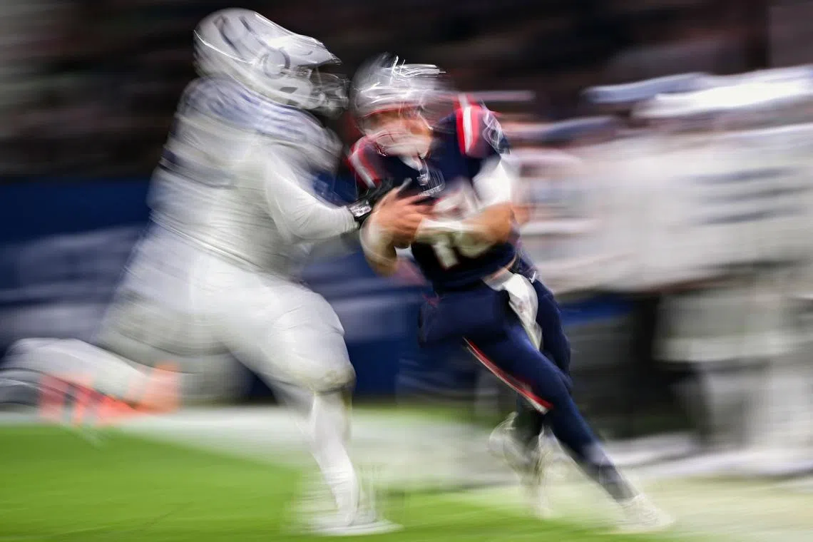 New England Patriots' quarterback Mac Jones is tackled by Indianapolis Colts' defensive tackle Adetomiwa Adebawore during the NFL American football match Indianapolis Colts vs New England Patriots at the Deutsche Bank Park in Frankfurt am Main, western Germany, on Nov 12, 2023. 