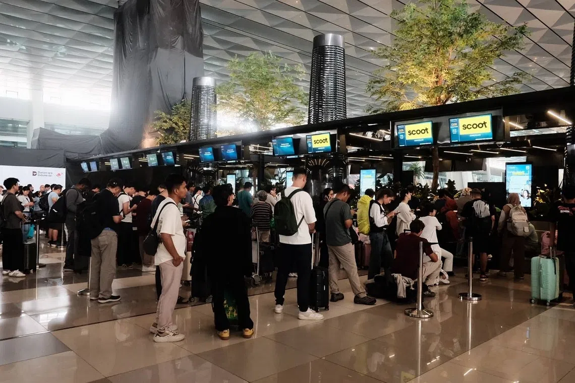 Passengers lining up at the Scoot Airlines counters at Soekarno-Hatta International Airport to reschedule flights cancelled due to the Anak Krakatau eruption, on Sept 6.