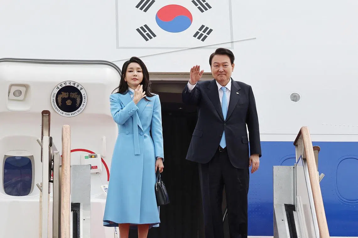 South Korea's President Yoon Suk Yeol (R) and his wife Kim Keon-hee (L) board a plane as they leave for Washington at Seoul Air Base in Seongnam on April 24, 2023.