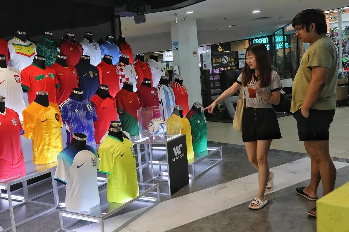 ST20221209_202211595921/Feline Lim/dgjersey11

Customers browsing World Cup jerseys at Weston Corp's store in Queensway Shopping Centre on 9 December 2022.