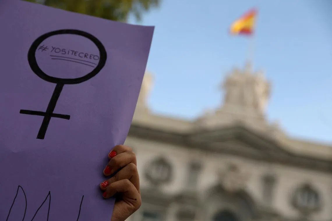 FILE PHOTO: Women gather outside the Supreme Court after Spain's top court found five men known as the \"Wolf Pack\" guilty of rape in Madrid, Spain, June 21, 2019. The banner reads: \"I believe you\". REUTERS/Susana Vera/File Photo