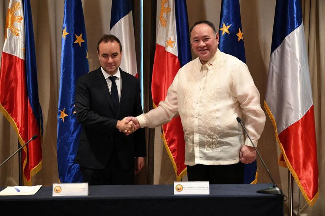 French Minister for the Armed Forces Sebastien Lecornu shakes hands with Philippine Secretary of National Defense Gilberto Teodoro during a joint press conference at a hotel in Manila, Philippines, December 2, 2023. Ted Aljibe/Pool via REUTERS