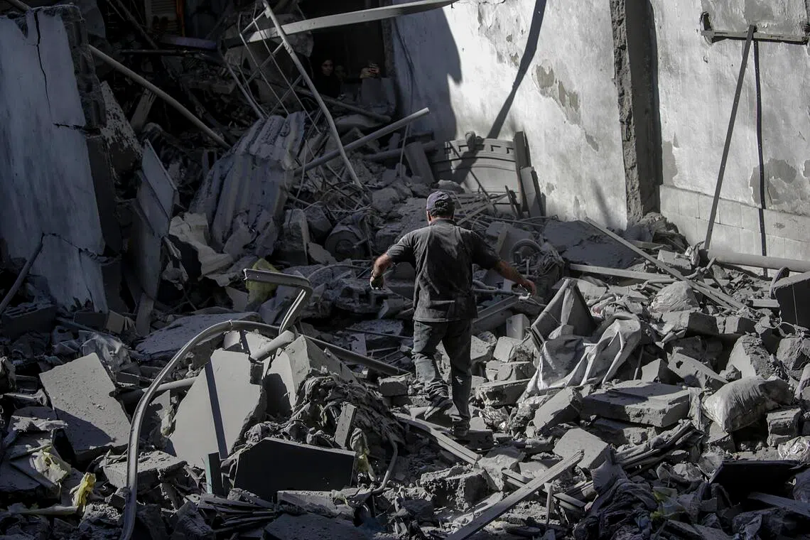 A man surveys the damage to his home following an Israeli airstrike targeting a residential block in Al Shatea refugee camp in Gaza City, on Oct 29, 2025. 