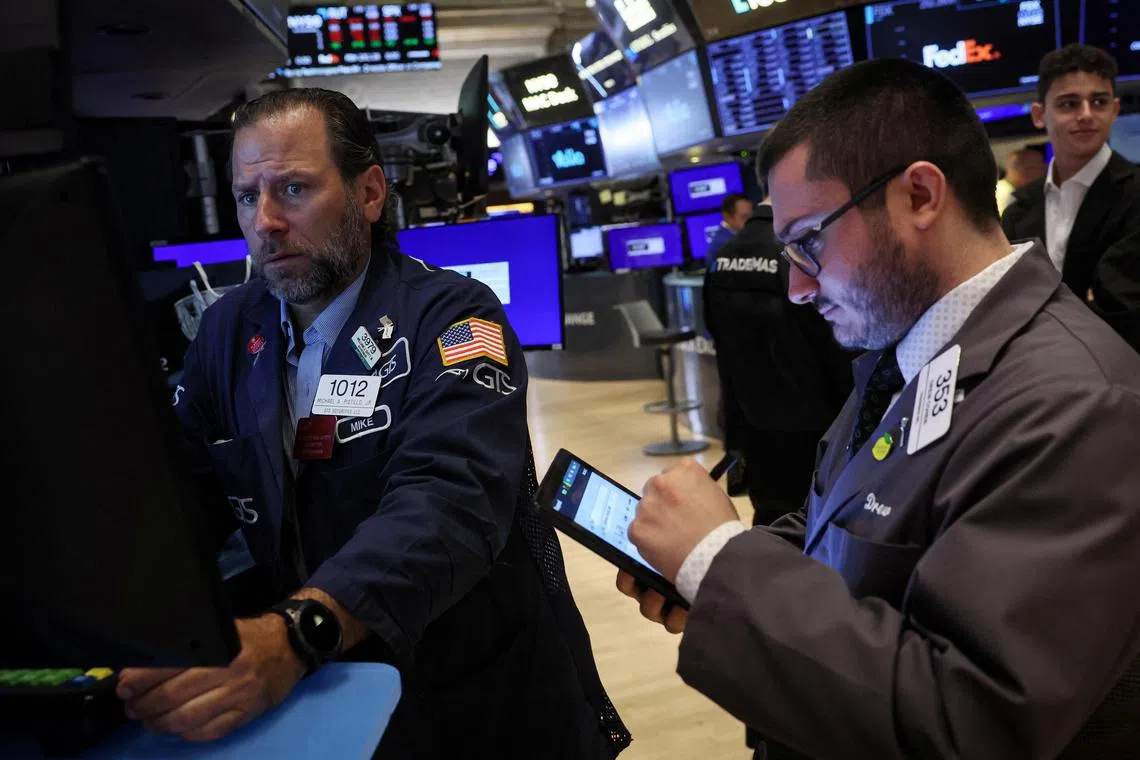 Traders work on the floor of the New York Stock Exchange, in New York City.