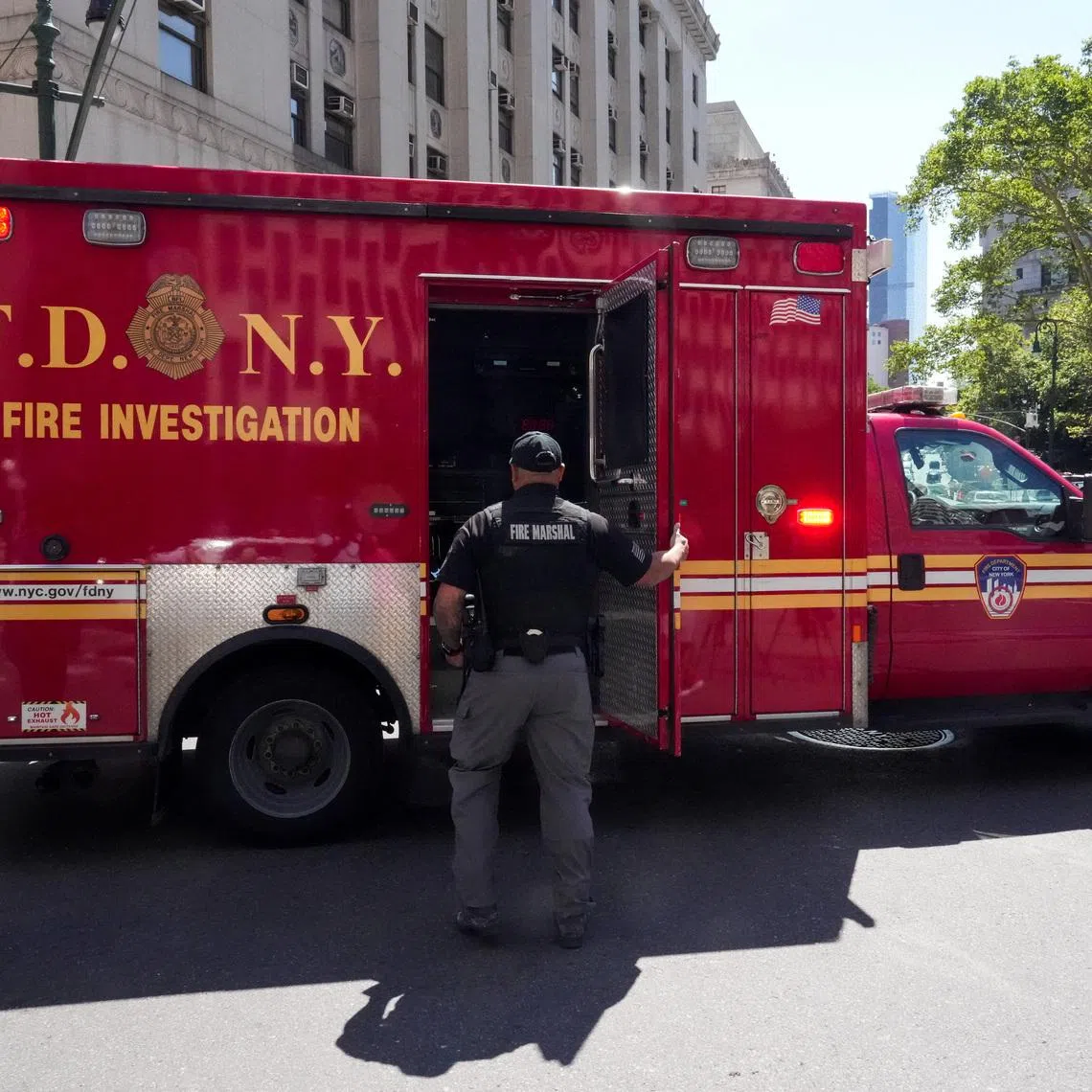 A New York City Fire Department (FDNY) truck stands parked outside 26 Federal Plaza, which houses the FBI's New York City field office and the Immigration and Customs Enforcement (ICE) field office, following reports that a person deployed an incendiary device, in New York City, U.S., July 20, 2026. REUTERS/David Dee Delgado