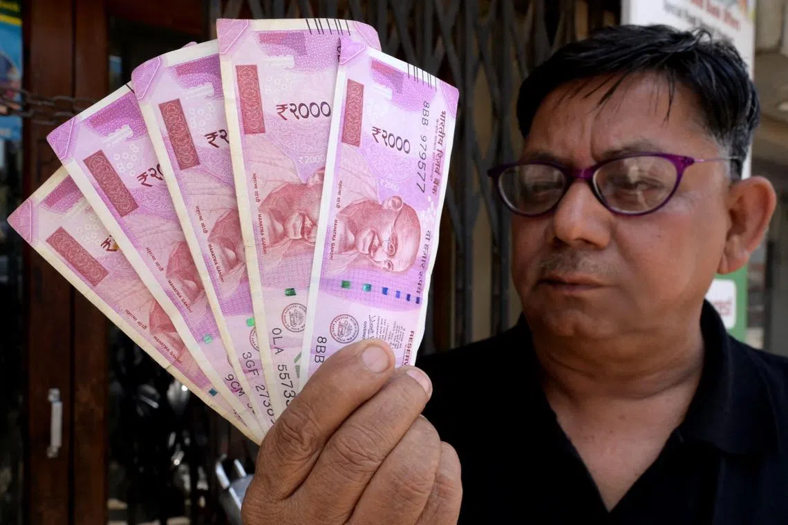 People in India have been thronging outlets to spend the 2,000-rupee note since the weekend.