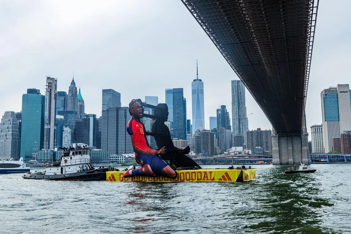 An Adidas barge, with an image of SpaniardLamine Yamal, floats on the East River on June 26.