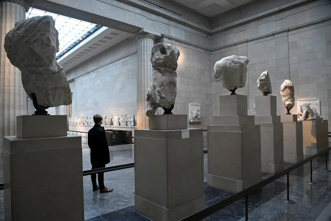 FILE PHOTO: An employee views examples of the Parthenon sculptures, sometimes referred to in the UK as the Elgin Marbles, on display at the British Museum in London, Britain, January 25, 2023. REUTERS/Toby Melville/File Photo
