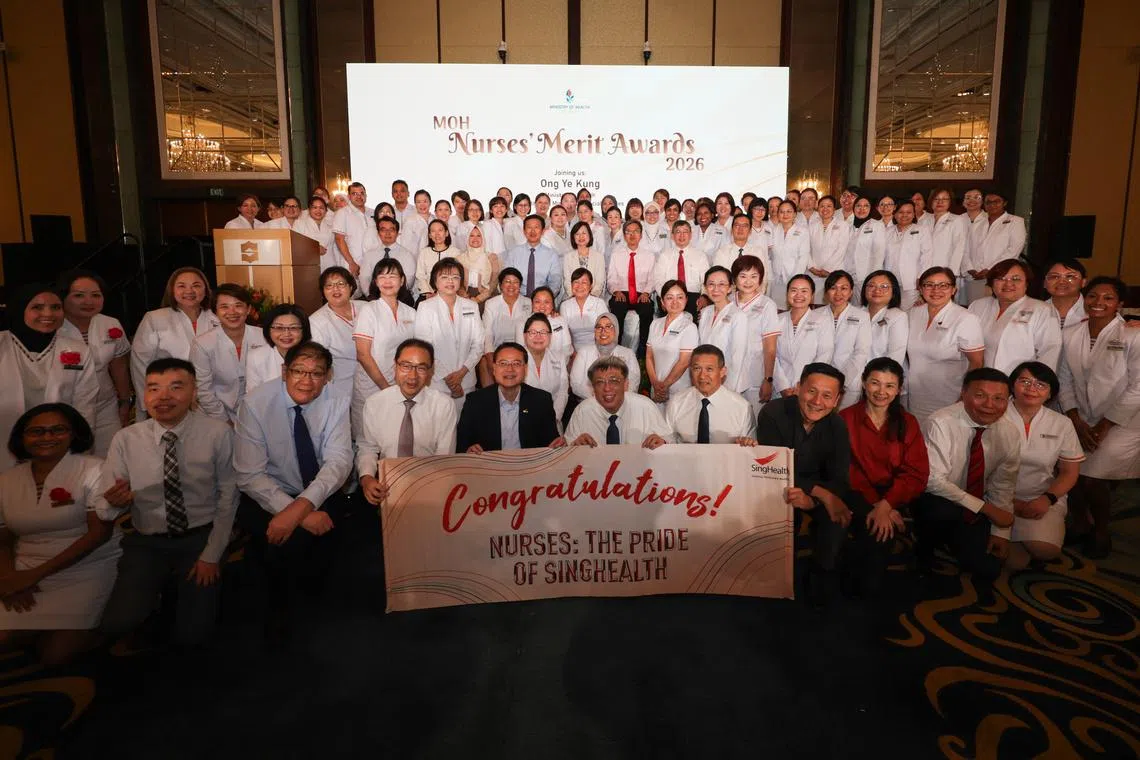 Health Minister Ong Ye Kung (middle row, fourth from left) at the Nurses’ Merit Award ceremony held at the Shangri-La Singapore on July 6.