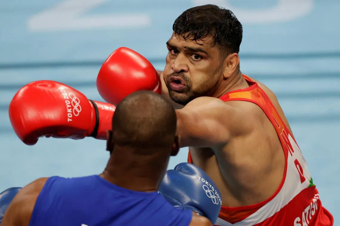 Boxers Satish Kumar of India and Ricardo Brown of Jamaica in action during the Tokyo Olympics in 2020.